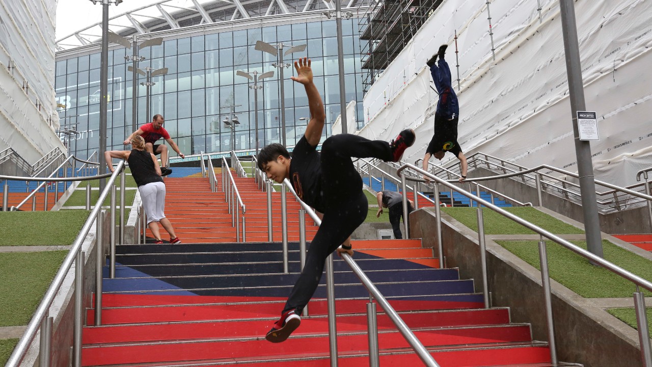 In this Aug. 16, 2018, file photo, participants of the Parkour Generations work on their practice runs outside of Wembley Stadium ahead of the 13th Rendezvous International Parkour Gathering in London. (Nishat Ahmed / AP)