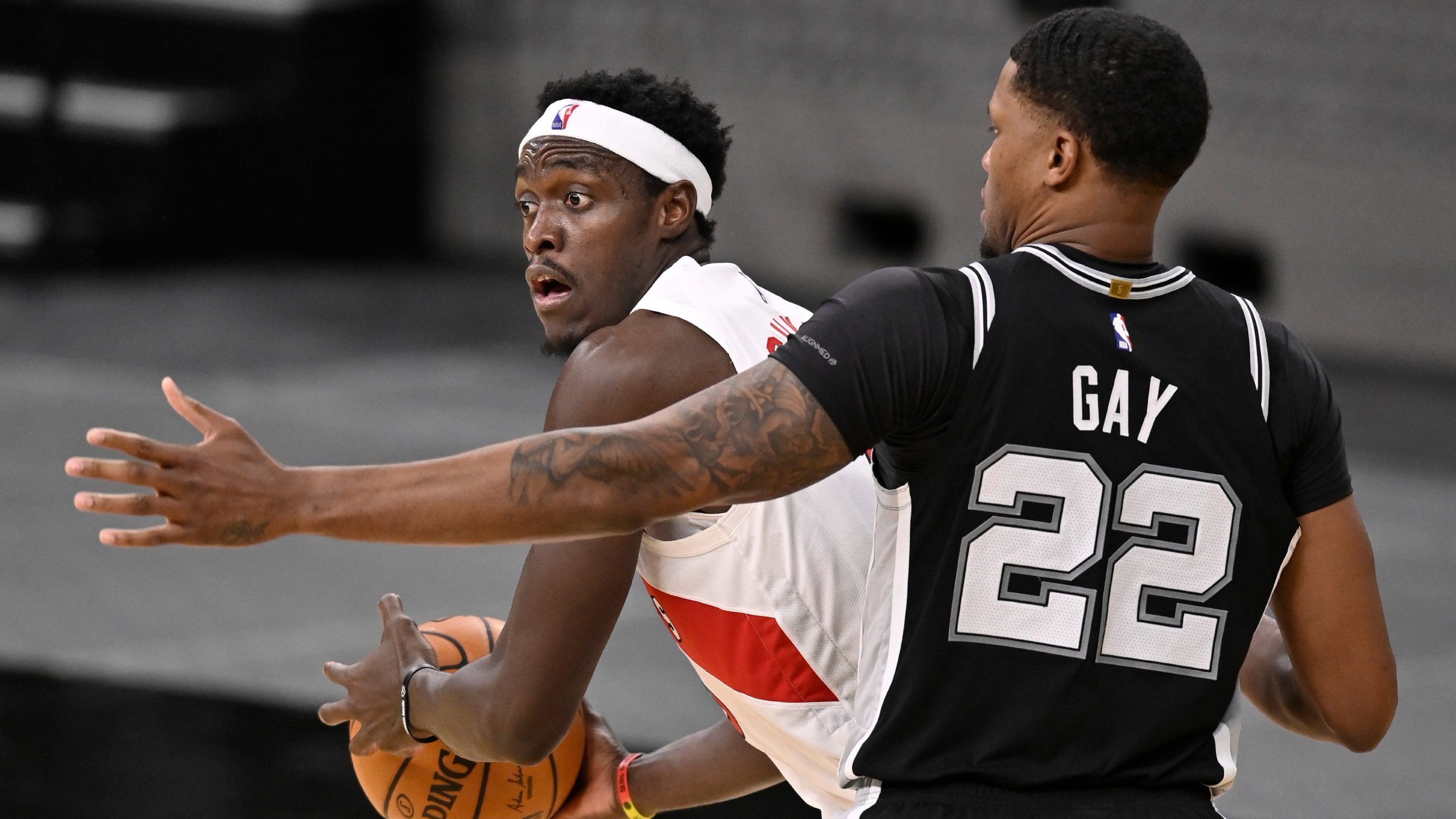 Toronto Raptors' Pascal Siakam, left, looks to pass as he is defended by San Antonio Spurs' Rudy Gay during the second half of an NBA basketball game. (Darren Abate/AP)