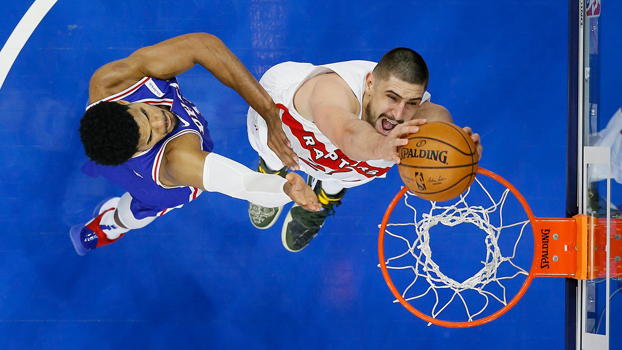 Toronto Raptors' Alex Len, right, goes up for a dunk against Philadelphia 76ers' Tobias Harris during the second half of an NBA basketball game, Tuesday, Dec. 29, 2020, in Philadelphia. (Matt Slocum/AP)