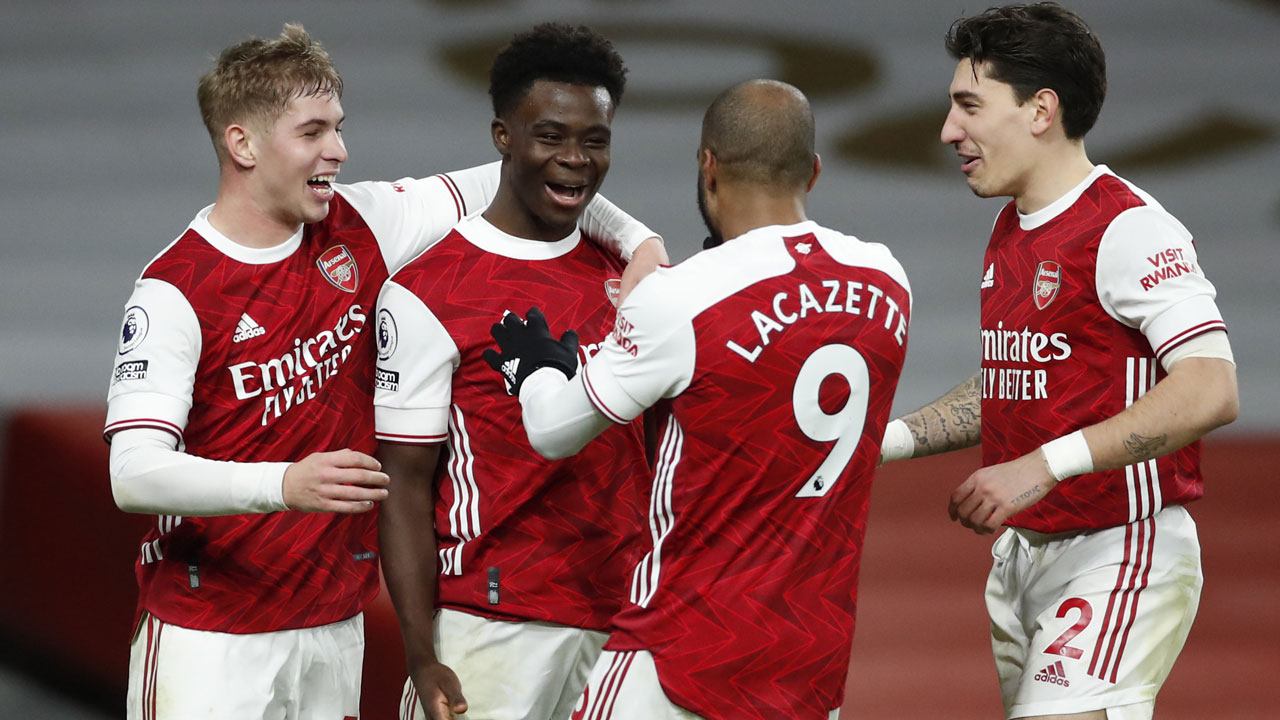 Arsenal's Bukayo Saka, second left, celebrates after scoring his sides 3rd goal of the game during their English Premier League soccer match between Arsenal and Chelsea. (Andrew Boyers/AP)