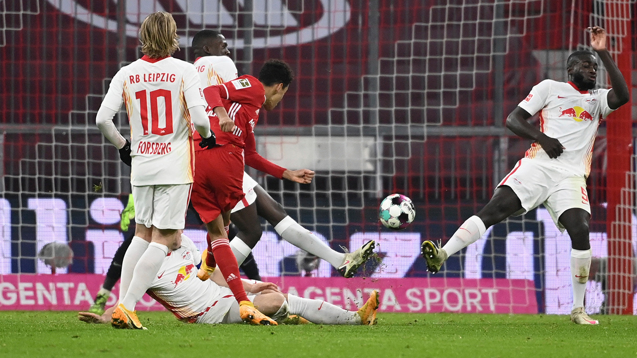 Bayern's Jamal Musiala, centre in red jersey, scores a goal during a Bundesliga match between Bayern Munich and RB Leipzig in Munich, Germany, Saturday, Dec. 5, 2020. (Sven Hoppe/dpa via AP)