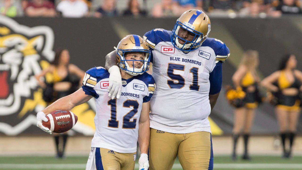 Winnipeg Blue Bombers wide receiver Ryan Smith (12) is congratulated by teammate Jermarcus Hardrick (51) after his touchdown during first half CFL football action against the Hamilton Tiger Cats, in Hamilton, Ont., on Thursday, July 7, 2016. (Peter Power/CP)