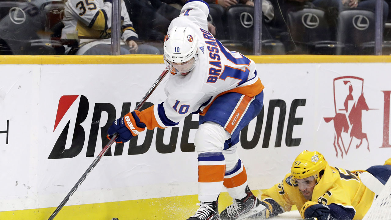 New York Islanders center Derick Brassard (10) gets past Nashville Predators defenseman Dante Fabbro (57) in the first period of an NHL hockey game. (Mark Humphrey/AP)