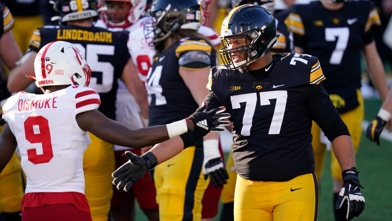 Iowa offensive lineman Alaric Jackson (77) greets Nebraska safety Marquel Dismuke (9) after an NCAA college football game, Friday, Nov. 27, 2020, in Iowa City, Iowa. Iowa won 26-20. (Charlie Neibergall / AP)