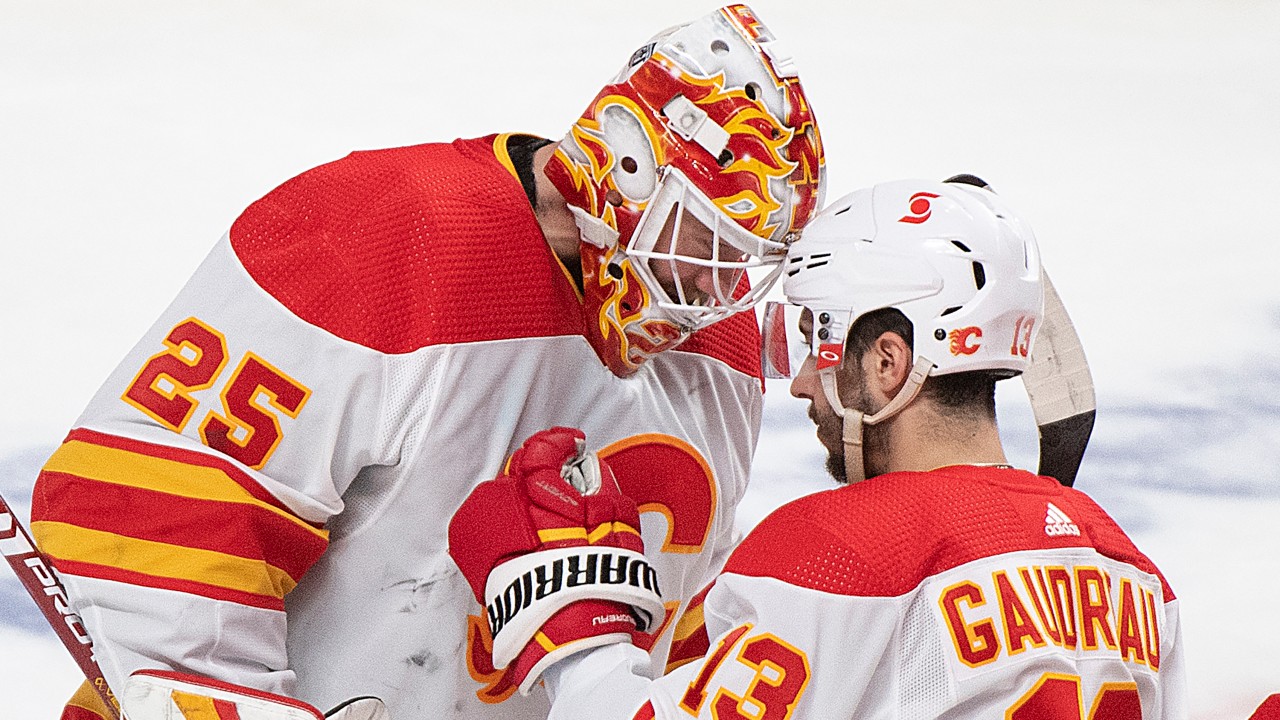 Calgary Flames goaltender Jacob Markstrom (25) celebrates with teammate Johnny Gaudreau after defeating the Montreal Canadiens in an NHL hockey game in Montreal, Saturday, January 30, 2021. (Graham Hughes / CP)