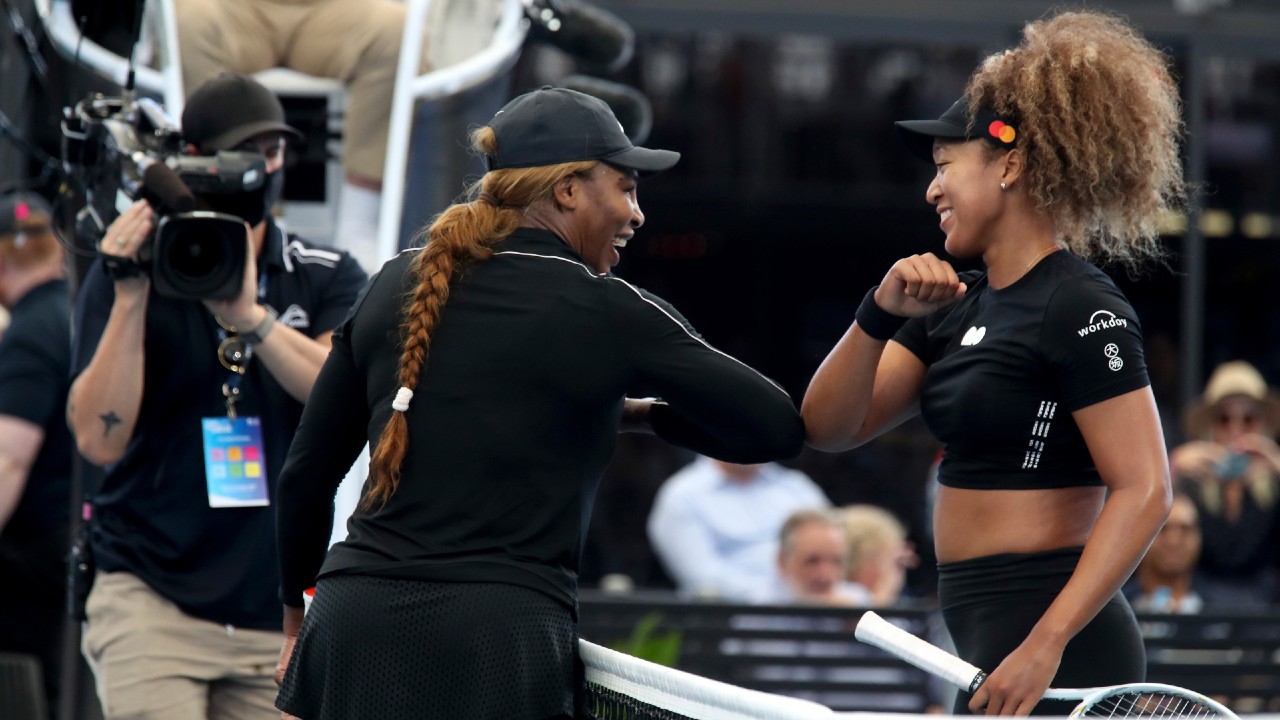Serena Williams, left, and Naomi Osaka gesture with their elbows following an exhibition tennis event in Adelaide, Australia. (Kelly Barnes/AAP Image via AP)