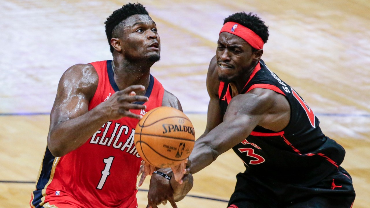 New Orleans Pelicans forward Zion Williamson (1) is fouled as he drives to the basket by Toronto Raptor forward Pascal Siakam (43). (Butch Dill/AP)