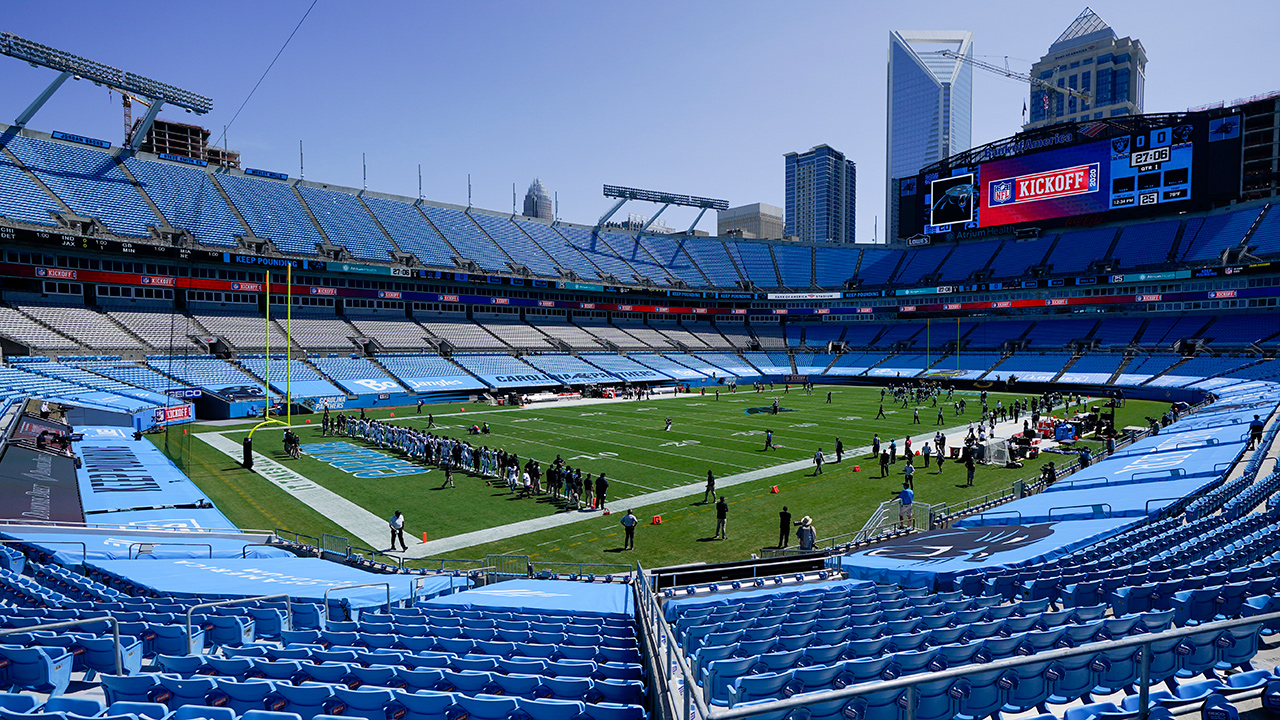 Members of the Carolina Panthers stand during a presentation in an empty Bank of America Stadium. (Chris Carlson/AP)