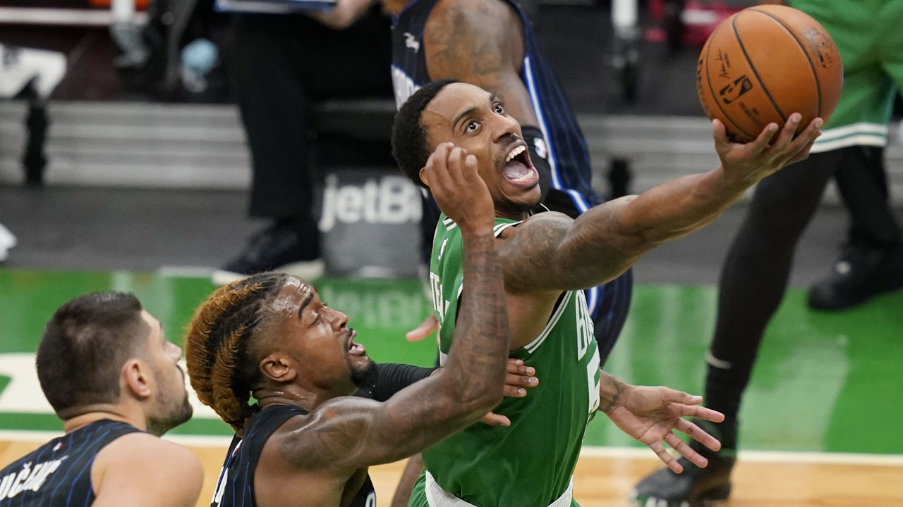 Boston Celtics guard Jeff Teague goes to the basket against the defense of Orlando Magic center Nikola Vucevic, left, and guard Jordan Bone during the first half of an NBA basketball game. (Elise Amendola/AP)