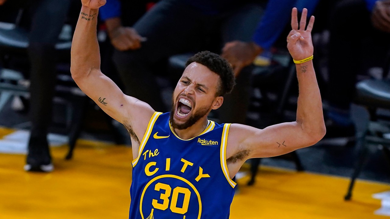 Golden State Warriors guard Stephen Curry celebrates after Andrew Wiggins made a 3-point shot. (Tony Avelar/AP)