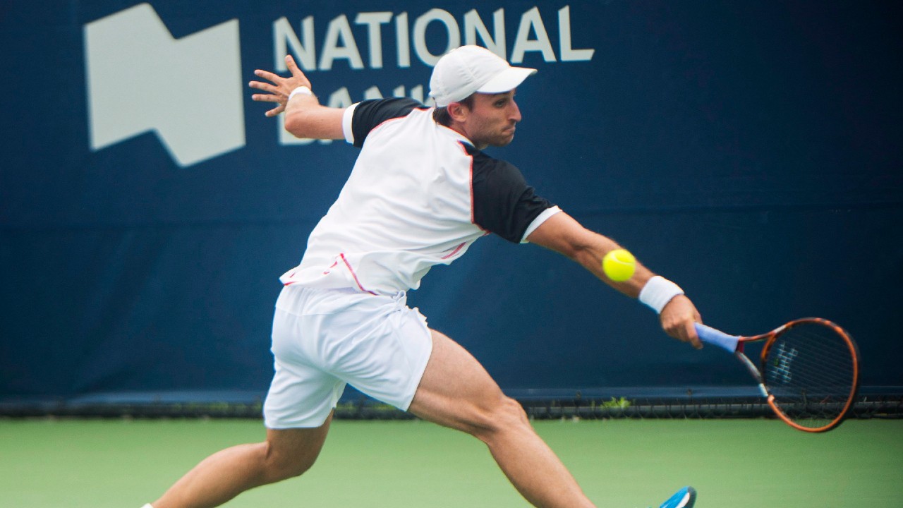 Steven Diez of Canada returns the ball against Kyle Edmund of Great Britain during men's first round Rogers Cup tennis action in Toronto on Monday, July 25, 2016. (Nathan Denette/CP)
