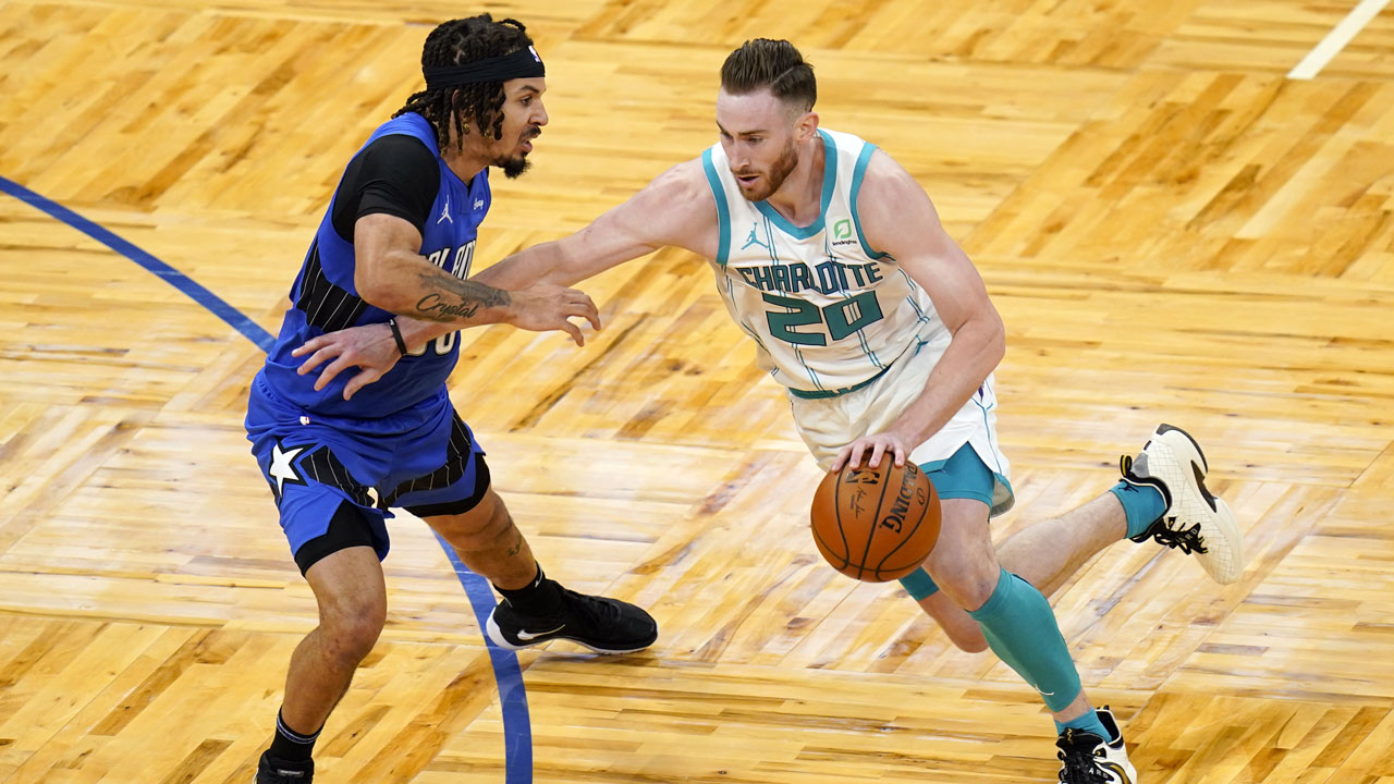 Charlotte Hornets forward Gordon Hayward (20) drives around Orlando Magic guard Cole Anthony during the second half of an NBA basketball game. (John Raoux/AP)