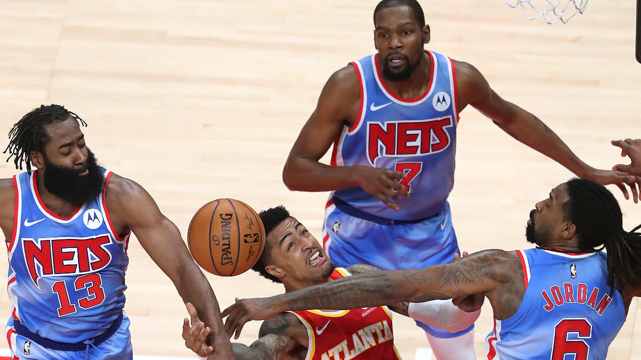 Brooklyn Nets' James Harden, Kevin Durant, and DeAndre Jordan, from left, defend against Atlanta Hawks' John Collins during an NBA basketball game Wednesday, Jan. 27, 2021, in Atlanta. (Curtis Compton/Atlanta Journal-Constitution via AP)
