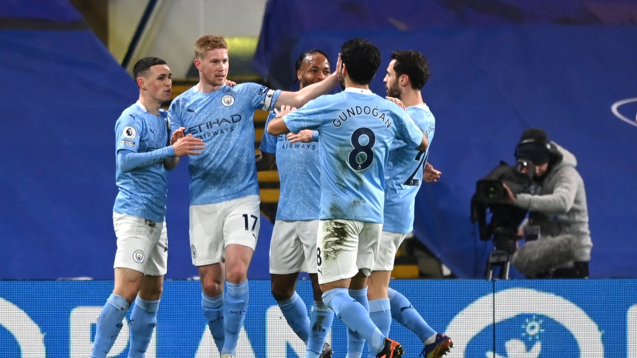 Manchester City's Phil Foden, left, celebrates with teammates after scoring their second goal during the English Premier League soccer match between Chelsea and Manchester City at Stamford Bridge, London, England, Sunday, Jan. 3, 2021. (Shaun Botterill/Pool via AP)
