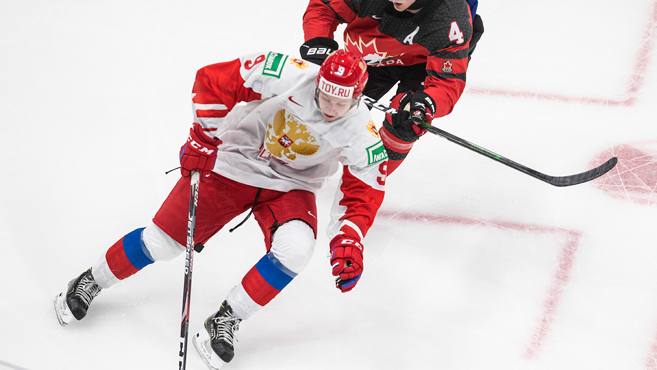 Canada's Bowen Byram (4) chases Russia's Mikhail Abramov (9) during first period IIHF World Junior Hockey Championship pre-competition action in Edmonton on Wednesday, December 23, 2020. (Jason Franson/CP)