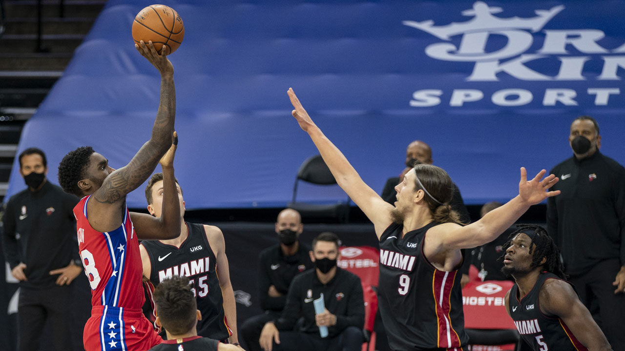 Philadelphia 76ers' Shake Milton, left, shoots the ball with Miami Heat's Kelly Olynyk, right defending during the second half of an NBA basketball game. (Chris Szagola/AP)