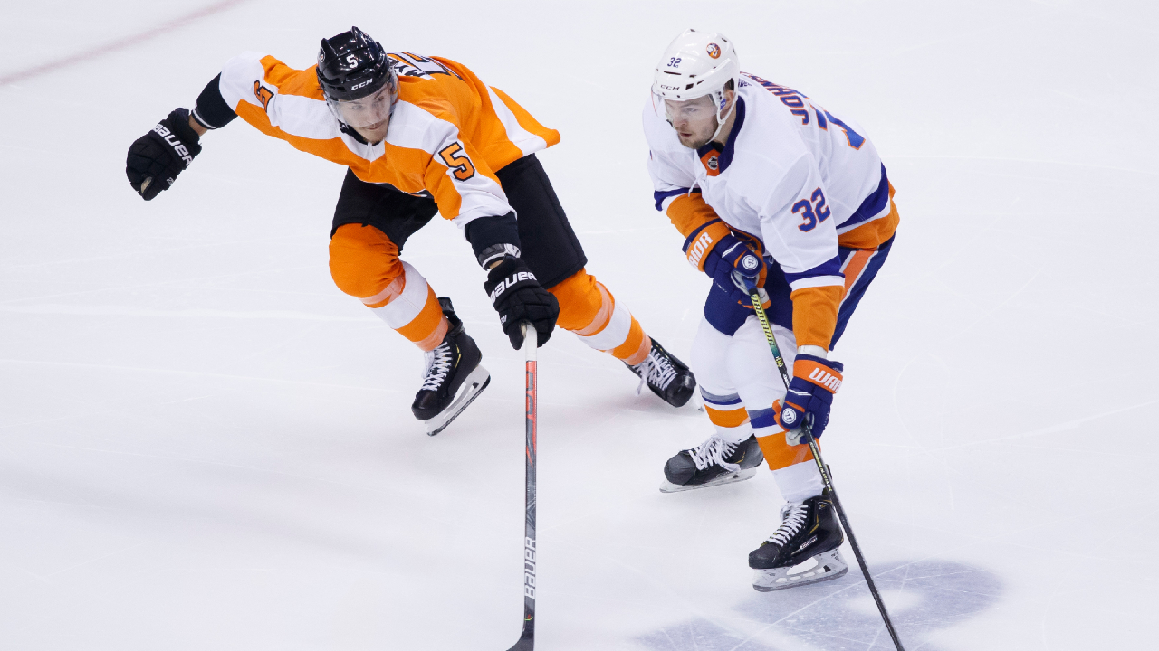 Philadelphia Flyers defenceman Philippe Myers (5) tries to defend against New York Islanders left wing Ross Johnston (32) during second period NHL Stanley Cup Eastern Conference playoff hockey action in Toronto, Wednesday, Aug. 26, 2020. (Cole Burston/CP)