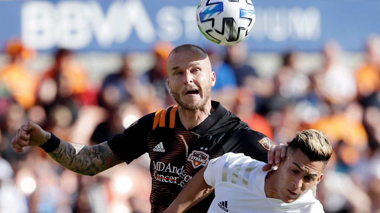 Houston Dynamo defender Kiki Struna, left, and LA Galaxy forward Cristian Pavón, right, vie for a head ball during the second half of an MLS soccer match Saturday, Feb. 29, 2020, in Houston. (Michael Wyke/AP)