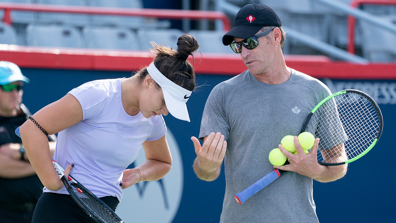 Bianca Andreescu listens to her coach Sylvain Bruneau during a practice session in Montreal on Monday, September 16, 2019. (Paul Chiasson/CP)