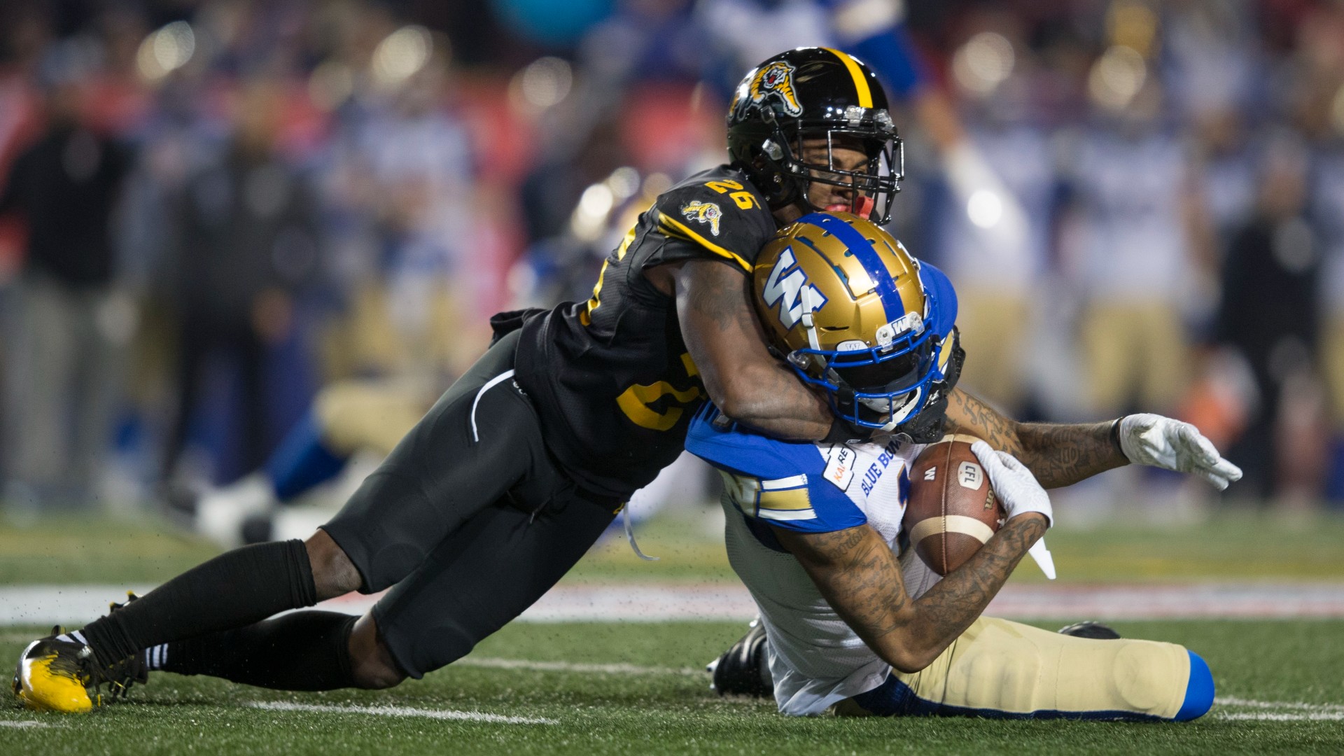 Hamilton Tiger-Cats' Cariel Brooks tackles Winnipeg Blue Bombers' Darvin Adams during first half football action in the 107th Grey Cup in Calgary, Alta., Sunday, November 24, 2019. (Todd Korol/CP)