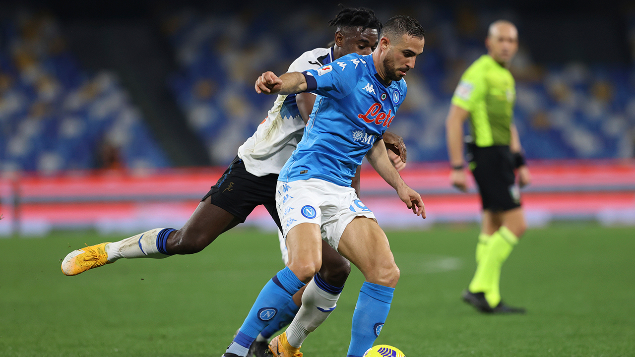 Atalanta's Duvan Zapata, left, battles for the ball with Napoli'sNikola Maksimovic during the Italian Cup, first-leg, semifinal soccer match between Napoli and Atalanta, at the Diego Armando Maradona Stadium in Naples, Italy, Wednesday, Feb. 3, 2021. (Alessandro Garofalo/LaPresse via AP)