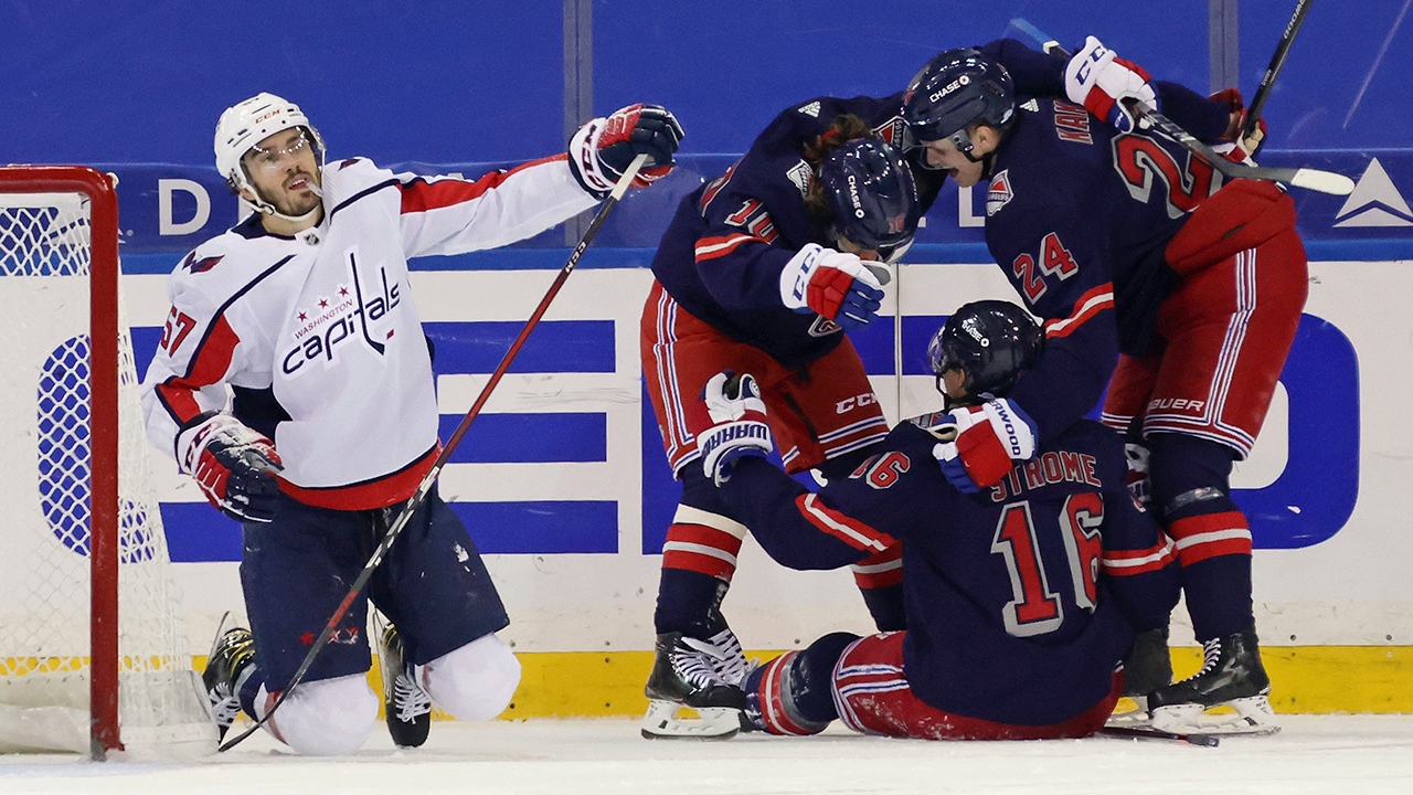 New York Rangers' Artemi Panarin, Ryan Strome and Kaapo Kakko, from left, celebrate Strome's goal, next to Washington Capitals' Trevor van Riemsdyk during the third period of an NHL hockey game Thursday, Feb. 4, 2021, in New York. (Bruce Bennett/Pool Photo via AP)