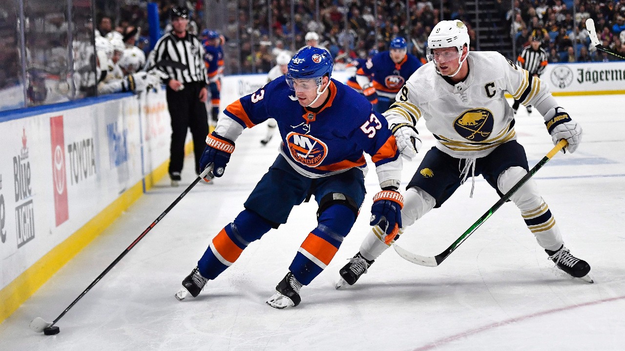 New York Islanders forward Casey Cizikas, left, shields the puck from Buffalo Sabres captain Jack Eichel. (Adrian Kraus/AP)