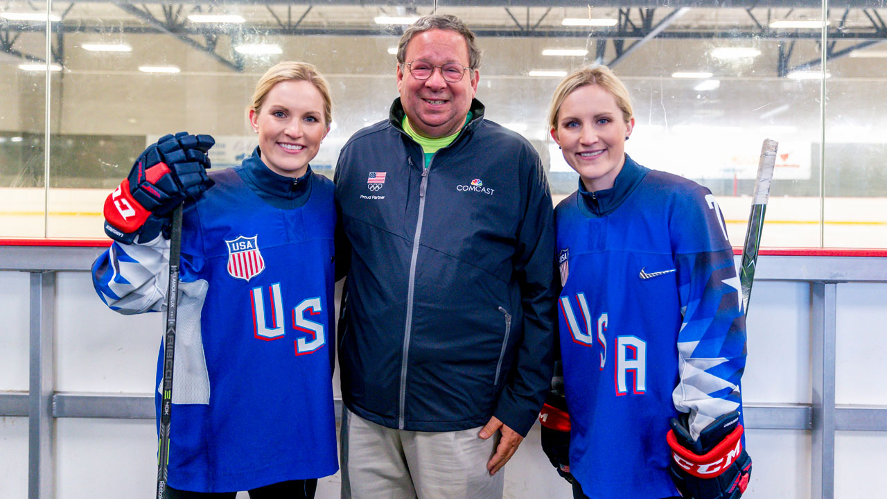 2018 Olympic gold medalists Jocelyne Lamoureux-Davidson and Monique Lamoureux-Morando pictured with Comcast Senior Executive Vice President & Chief Diversity Officer David L. Cohen. (Jeff Fusco/AP Images for Comcast)