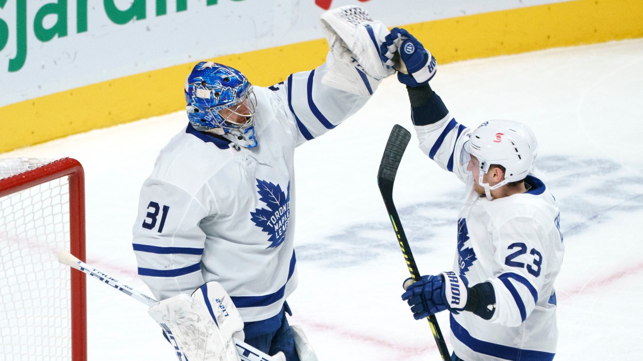 Toronto Maple Leafs goaltender Frederik Andersen and Travis Dermott celebrate their victory over the Montreal Canadiens in NHL hockey action. (Paul Chiasson/CP)