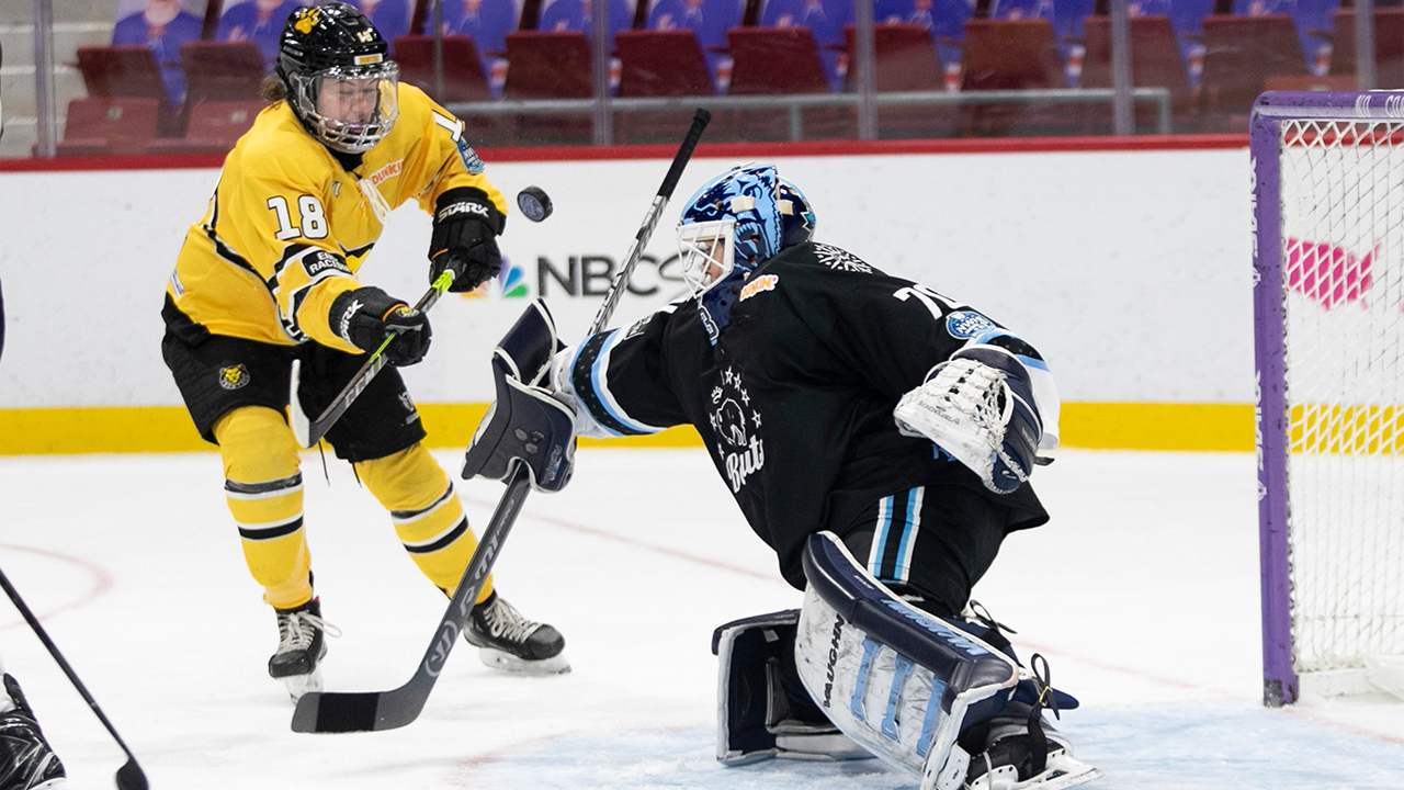 Former Buffalo Beauts goaltender Carly Jackson makes a save on Boston Pride forward Taylor Wenczkowski in Lake Placid. (Michelle Jay)