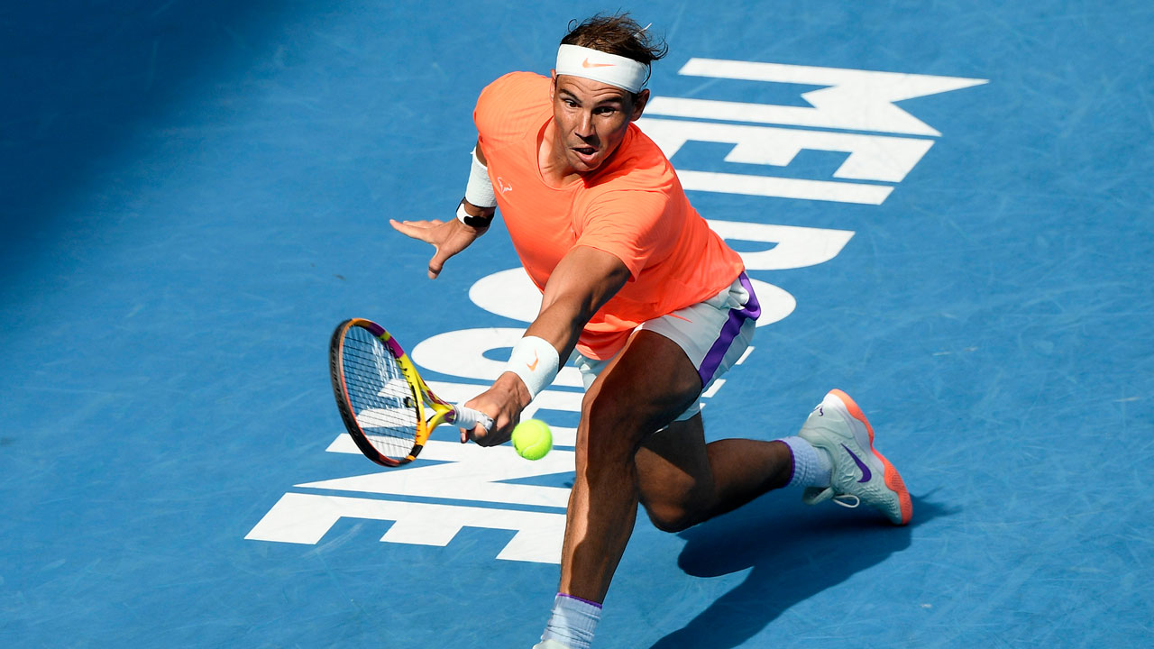 Rafael Nadal hits a backhand return to Fabio Fognini during their fourth round match at the Australian Open. (Andy Brownbill/AP)
