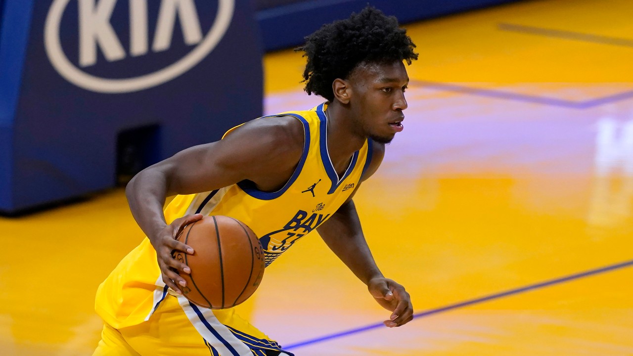 Golden State Warriors center James Wiseman brings the ball up during the second half of the team's NBA basketball game against the Detroit Pistons. (Jeff Chiu/AP)