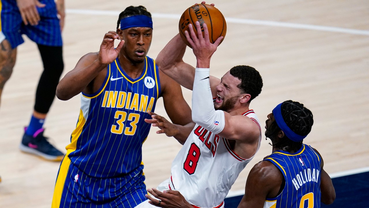 Chicago Bulls guard Zach LaVine (8) tries to shoot between Indiana Pacers center Myles Turner (33) and guard Justin Holiday (8) during the first half of an NBA basketball game. (Michael Conroy/AP) 