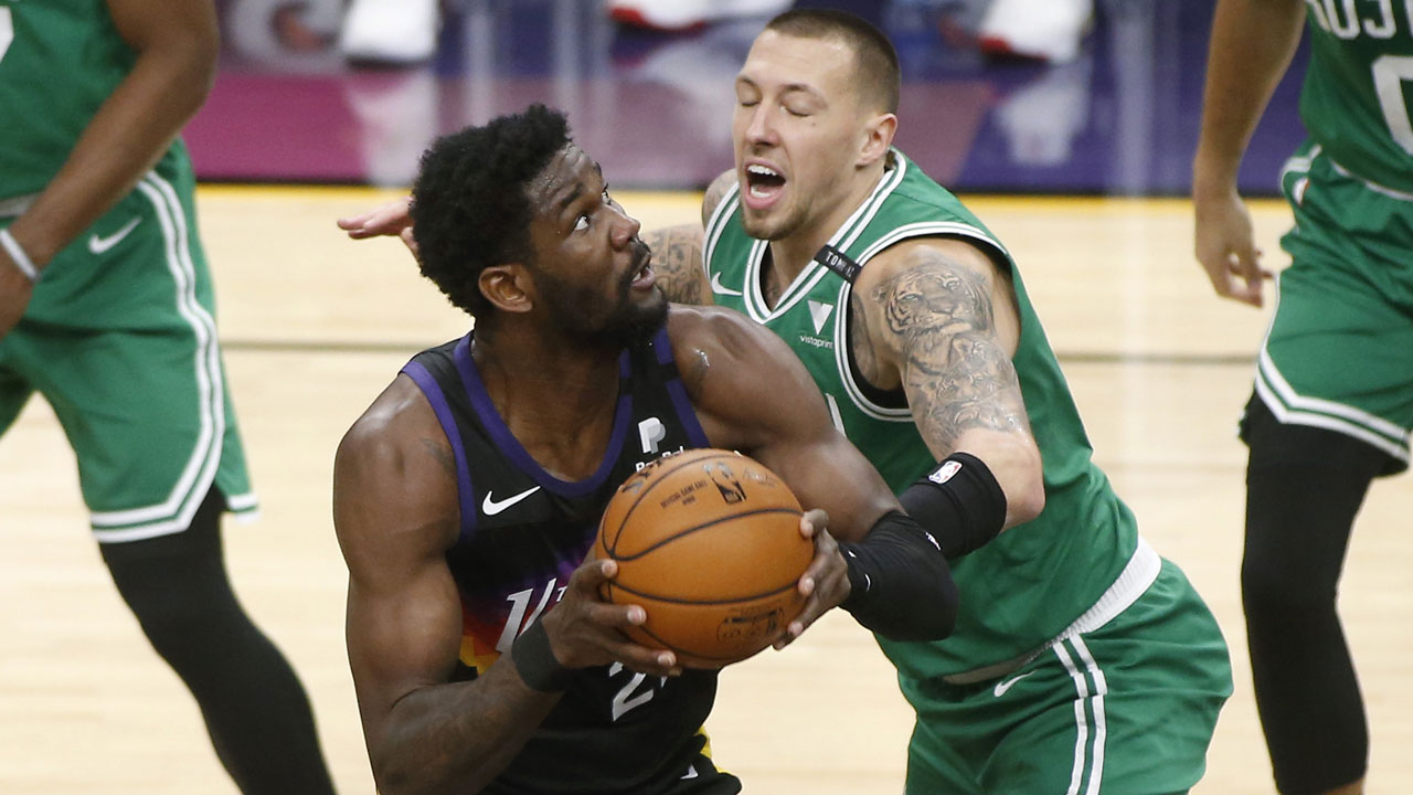Phoenix Suns center Deandre Ayton, left, looks to shoot as Boston Celtics forward Daniel Theis defends during the first half of an NBA basketball game. (Ralph Freso/AP)