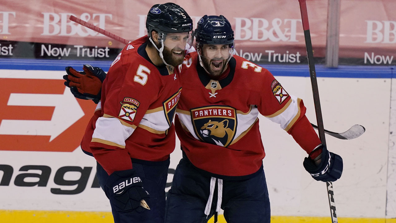 Florida Panthers defenseman Keith Yandle (3) congratulates defenseman Aaron Ekblad (5) after Ekblad scored a goal during the second period at an NHL hockey game against the Tampa Bay Lightning. (Marta Lavandier/AP)