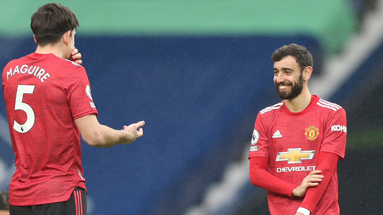 Manchester United's Harry Maguire, left, shares a moment with teammate Bruno Fernandes. (Naomi Baker/Pool Photo via AP)