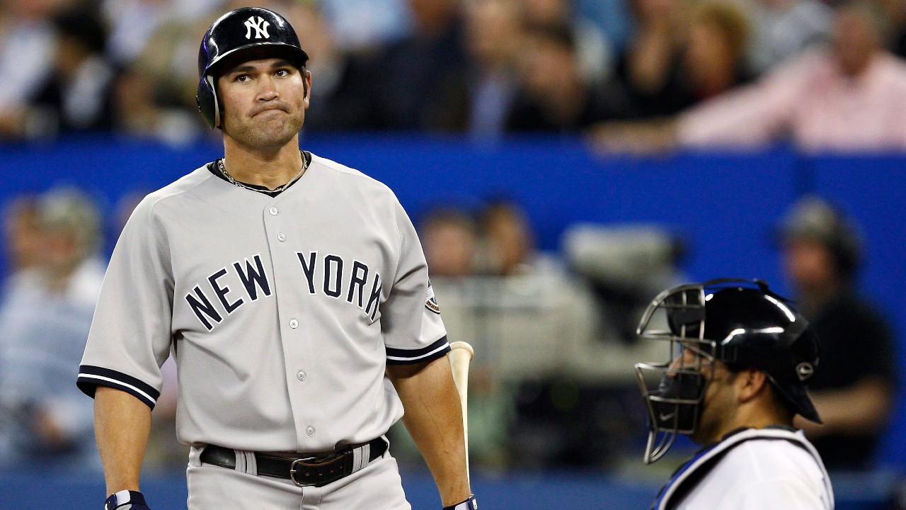New York Yankees left fielder Johnny Damon, left, reacts after a strike as Toronto Blue Jays catcher Rod Barajas, right, look on during nineth inning AL baseball action in Toronto on Tuesday, May 12, 2009. (Nathan Denette/CP)
