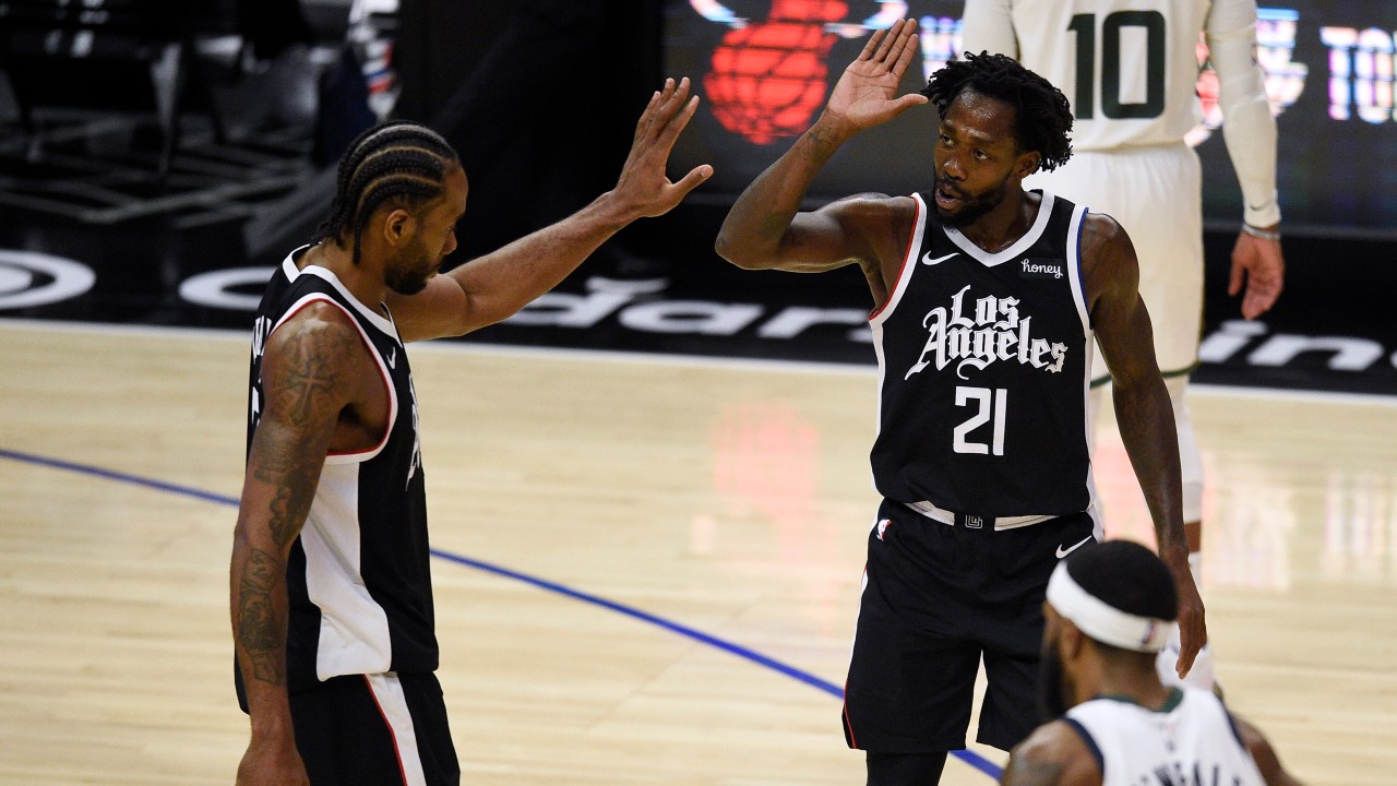 Los Angeles Clippers guard Patrick Beverley, right, celebrates with forward Kawhi Leonard during the second half of the team's NBA basketball game against the Utah Jazz in Los Angeles, Friday, Feb. 19, 2021. (AP Photo/Kelvin Kuo)