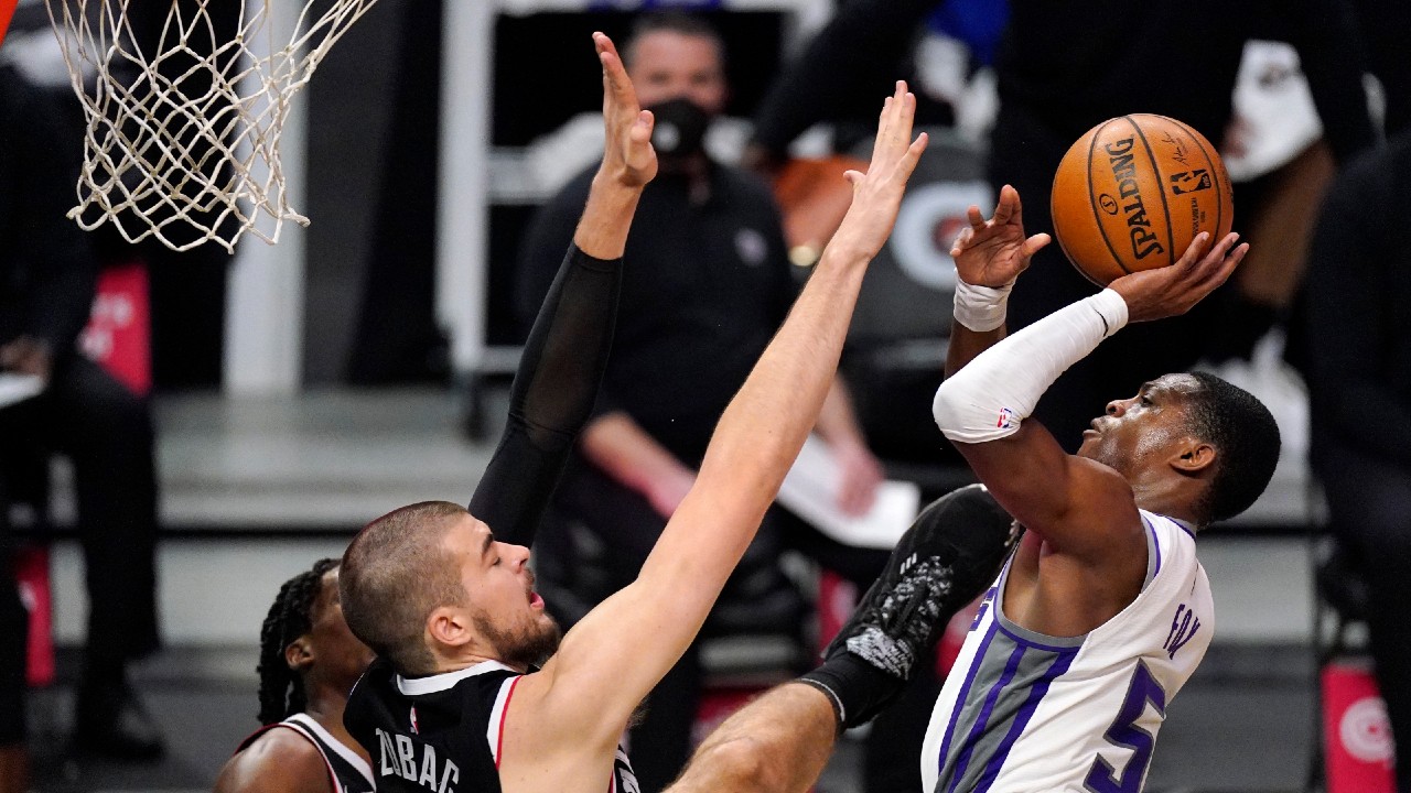 Sacramento Kings guard De'Aaron Fox, right, shoots as Los Angeles Clippers center Ivica Zubac defends during the second half of an NBA basketball game Sunday, Feb. 7, 2021, in Los Angeles. (Mark J. Terrill/AP)