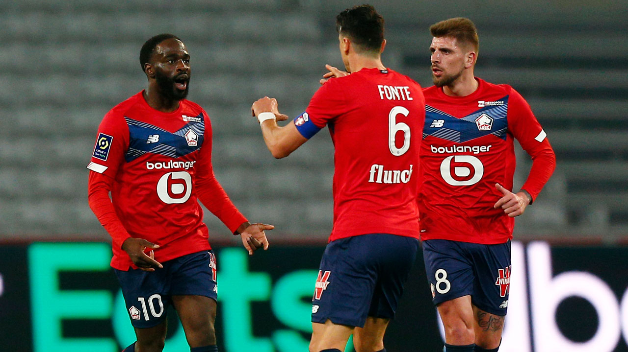 From left, Lille's Jonathan Ikone, Jose Fonte and Xeka celebrate after a goal during their French League One soccer match between Lille and Strasbourg. (Michel Spingler/AP)