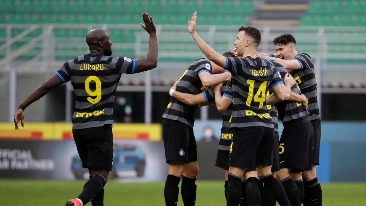 Inter Milan's Romelu Lukaku, left, celebrates with his teammate Ivan Perisic after their teammate Alexis Sanchez scoed his side's third goal during a Serie A soccer match between Inter Milan and Genoa at the San Siro stadium. (Luca Bruno/AP)