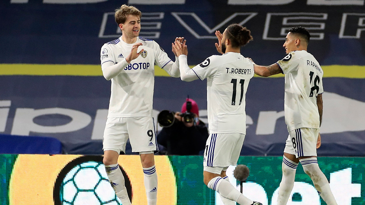 Leeds United's Patrick Bamford, left, celebrates after scoring the opening goal during the Premier League match between Leeds United and Southampton at Elland Road in Leeds, England, Tuesday, Feb. 23, 2021. (Mike Egerton/Pool via AP)