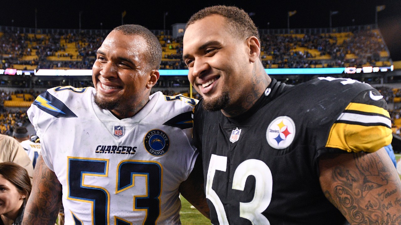 FILE - In this Dec. 2, 2018, file photo, Pittsburgh Steelers center Maurkice Pouncey, right, and his brother, Los Angeles Chargers center Mike Pouncey pose after playing against each other in an NFL football game in Pittsburgh. The twin brothers announced their retirement from professional football on Friday, Feb. 12, 2021. (Don Wright/AP)