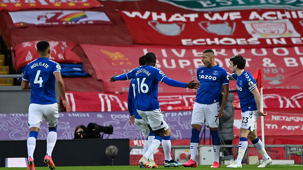 Everton's Richarlison, second right celebrates a with teammates after scoring the opening goal of the game during the English Premier League soccer match between Liverpool and Everton at Anfield in Liverpool, England, Saturday, Feb. 20, 2021. (Lawrence Griffiths/ Pool via AP)