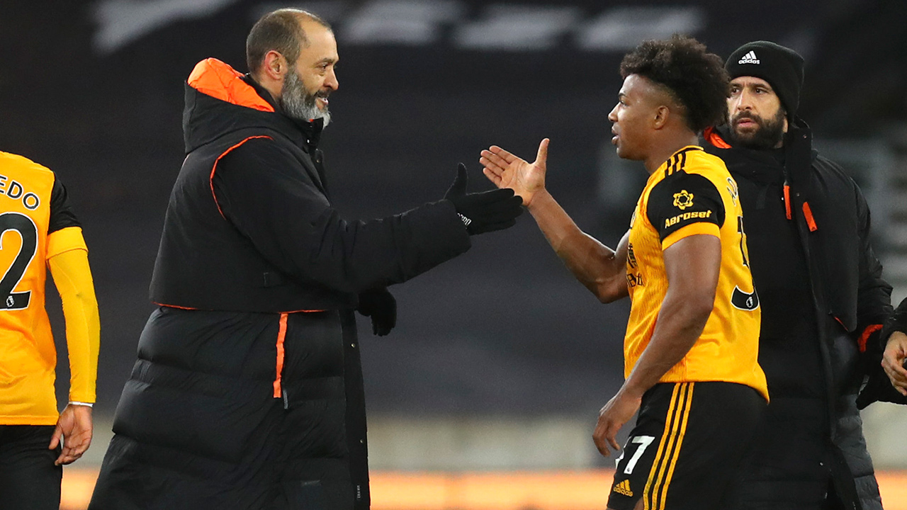 Wolverhampton Wanderers' head coach Nuno Espirito Santo and Adama Traore celebrate after the Premier League match between Wolverhampton Wanderers and Leeds United at the Molineux Stadium in Wolverhampton, England, Friday, Feb. 19, 2021. (Catherine Ivill/Pool via AP)