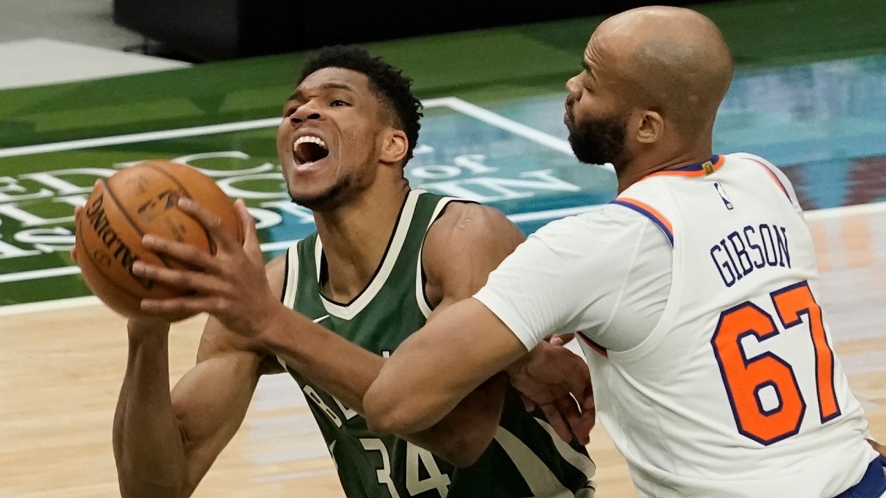 Milwaukee Bucks' Giannis Antetokounmpo is fouled by New York Knicks' Taj Gibson during the second half of an NBA basketball game. (Morry Gash/AP)