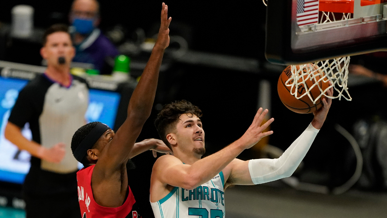 Charlotte Hornets guard Nate Darling (30) shoots past Toronto Raptors guard Paul Watson during the second half of an NBA preseason basketball game in Charlotte, N.C., on Saturday, Dec. 12, 2020. (AP Photo/Chris Carlson)