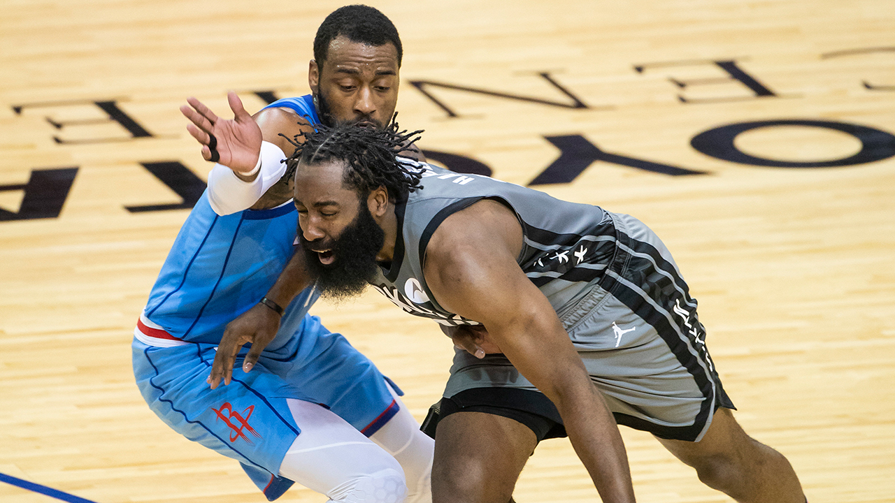 Brooklyn Nets guard James Harden (13) drives around Houston Rockets guard John Wall (1) during the first half of an NBA basketball game Wednesday, March 3, 2021, in Houston. (Mark Mulligan/Houston Chronicle via AP)