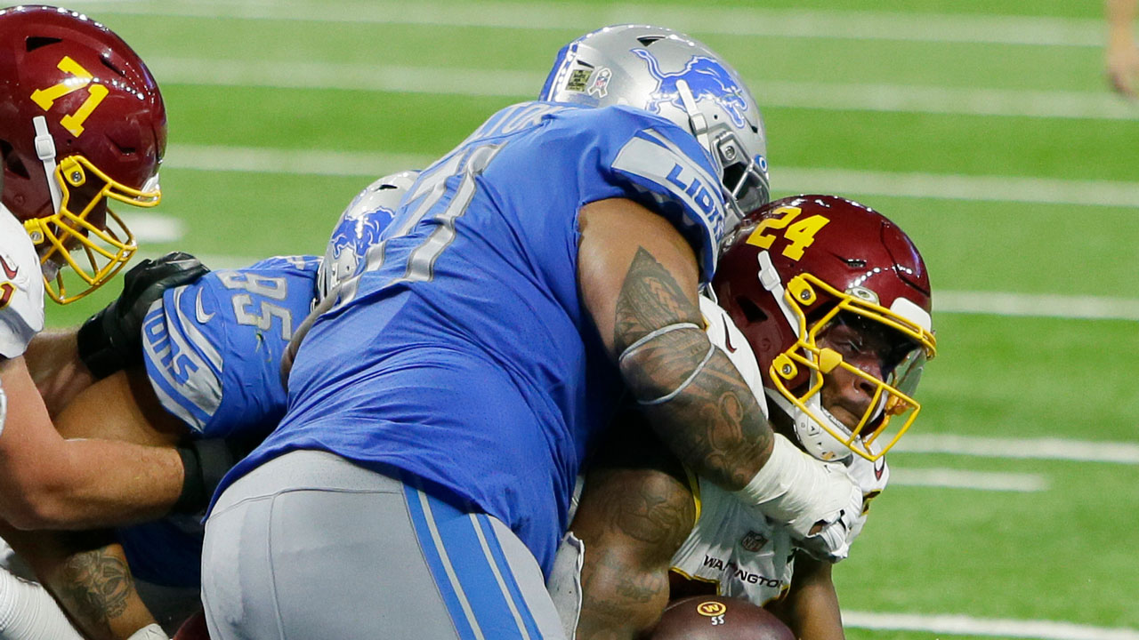 Washington Football Team running back Antonio Gibson (24), is tackled by Detroit Lions nose tackle Danny Shelton. (Duane Burleson/AP)