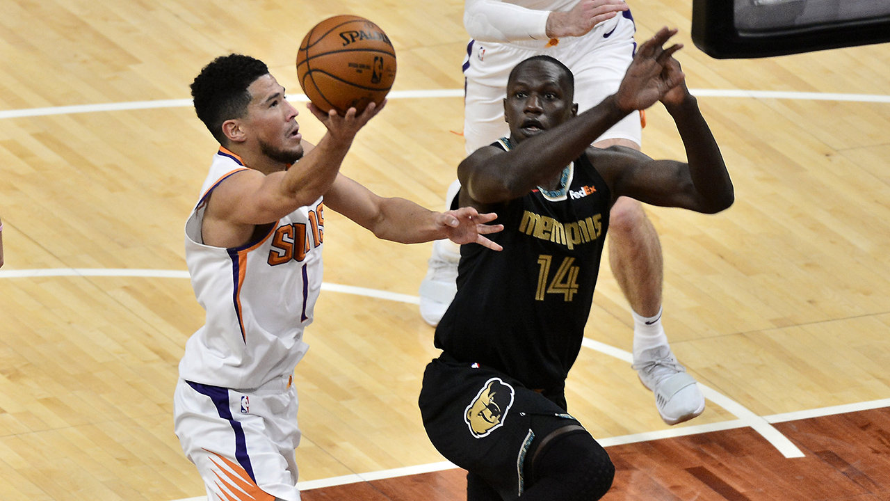 Phoenix Suns guard Devin Booker (1) shoots against Memphis Grizzlies center Gorgui Dieng (14) in the first half of an NBA basketball game Monday, Jan. 18, 2021, in Memphis, Tenn. (Brandon Dill/AP)